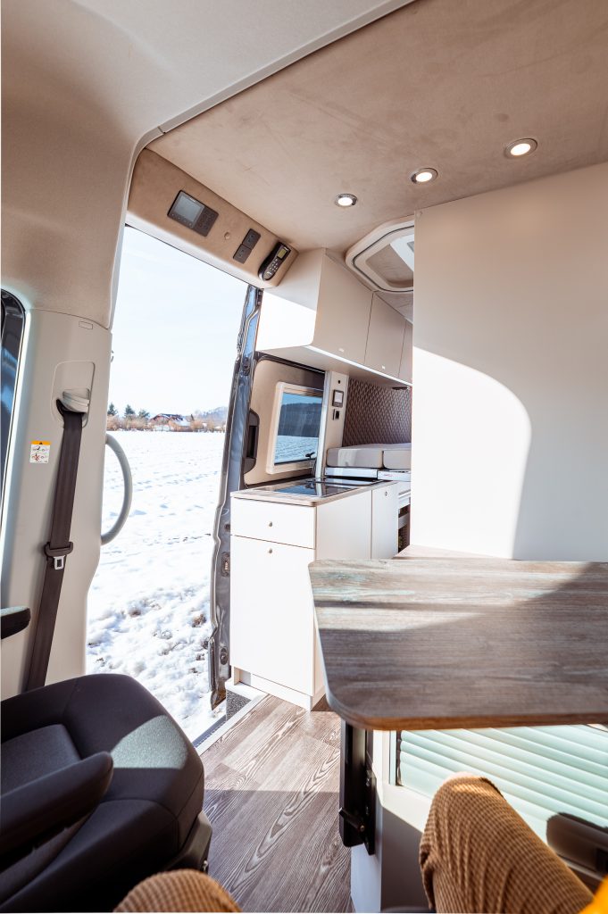 View of the lounge area; sliding door open; snowy landscape